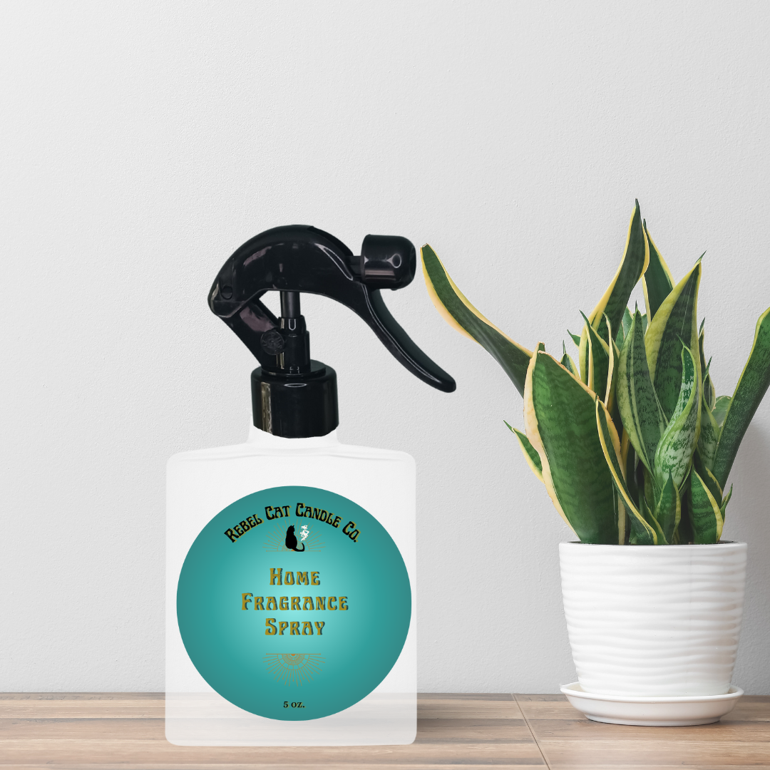 white frosted glass bottle with spray nozzle and plant in the background