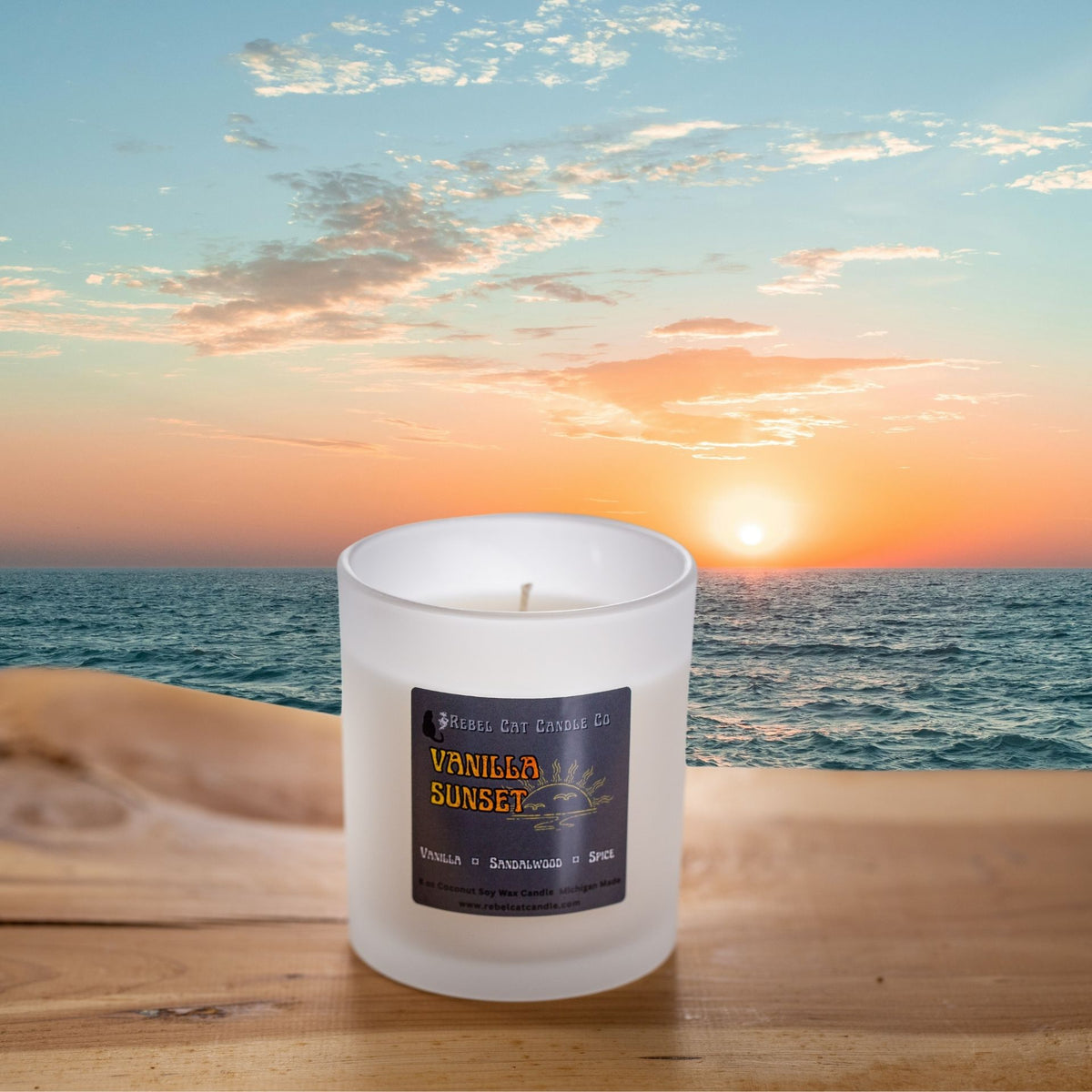Frosted 8 oz candle jar on a table with a sunset in the background